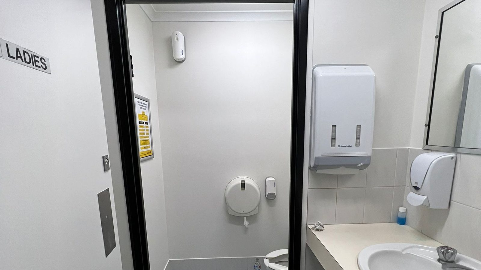 Amenities area with the walls set and finished above the tiling and a partition to one side