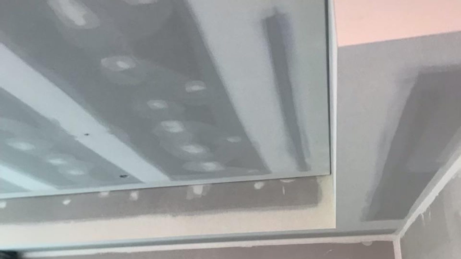 Close view of a bulkhead edge and ceiling with the joints coated and the fixings spotted