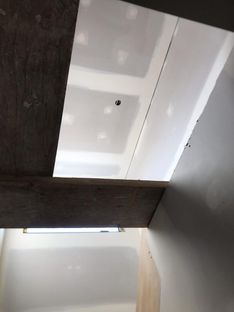 Bulkhead set and coated beside an exposed timber beam