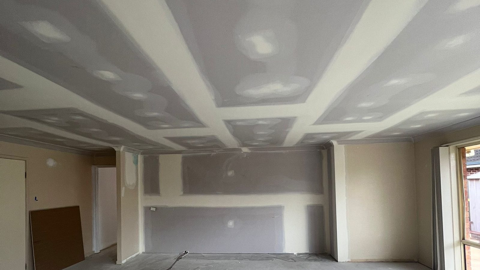 Ceiling and bulkhead sheeted and coated, the joints spread wide ready for sanding