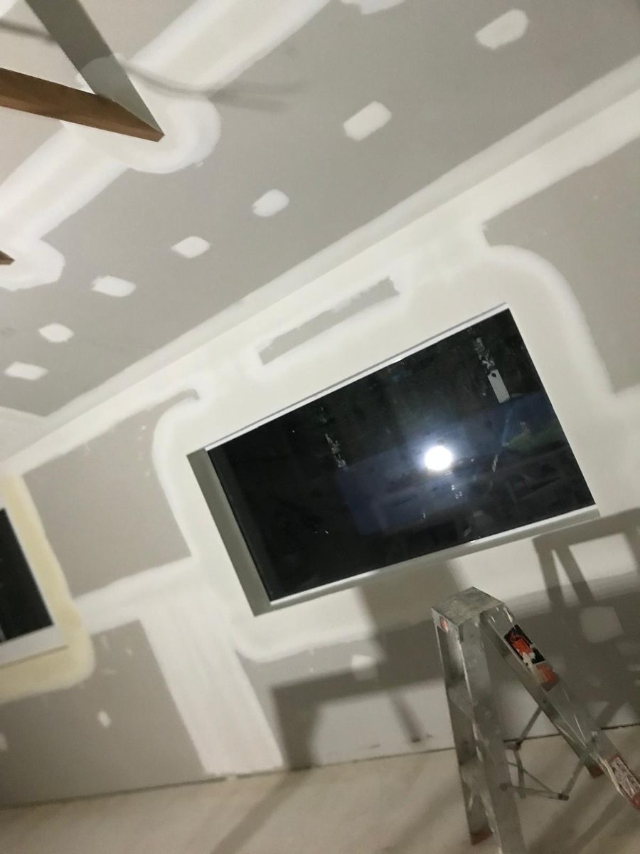 Ceiling with a recessed panel and a service opening, the joints coated and ready to sand