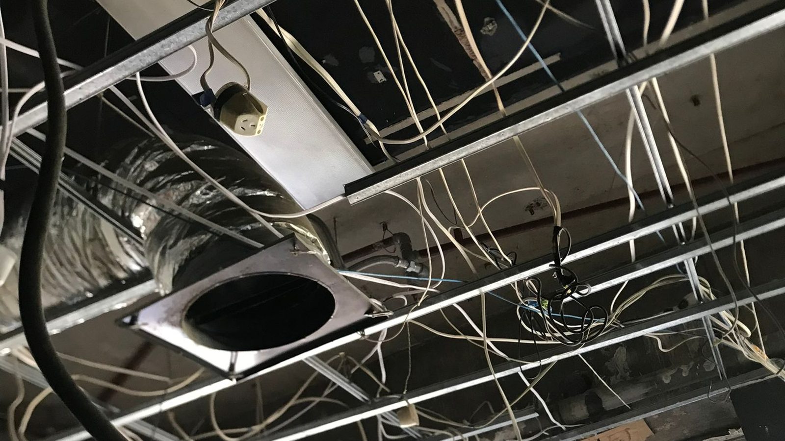 Ducting, cabling and the suspension grid in place above a ceiling before the lining goes on