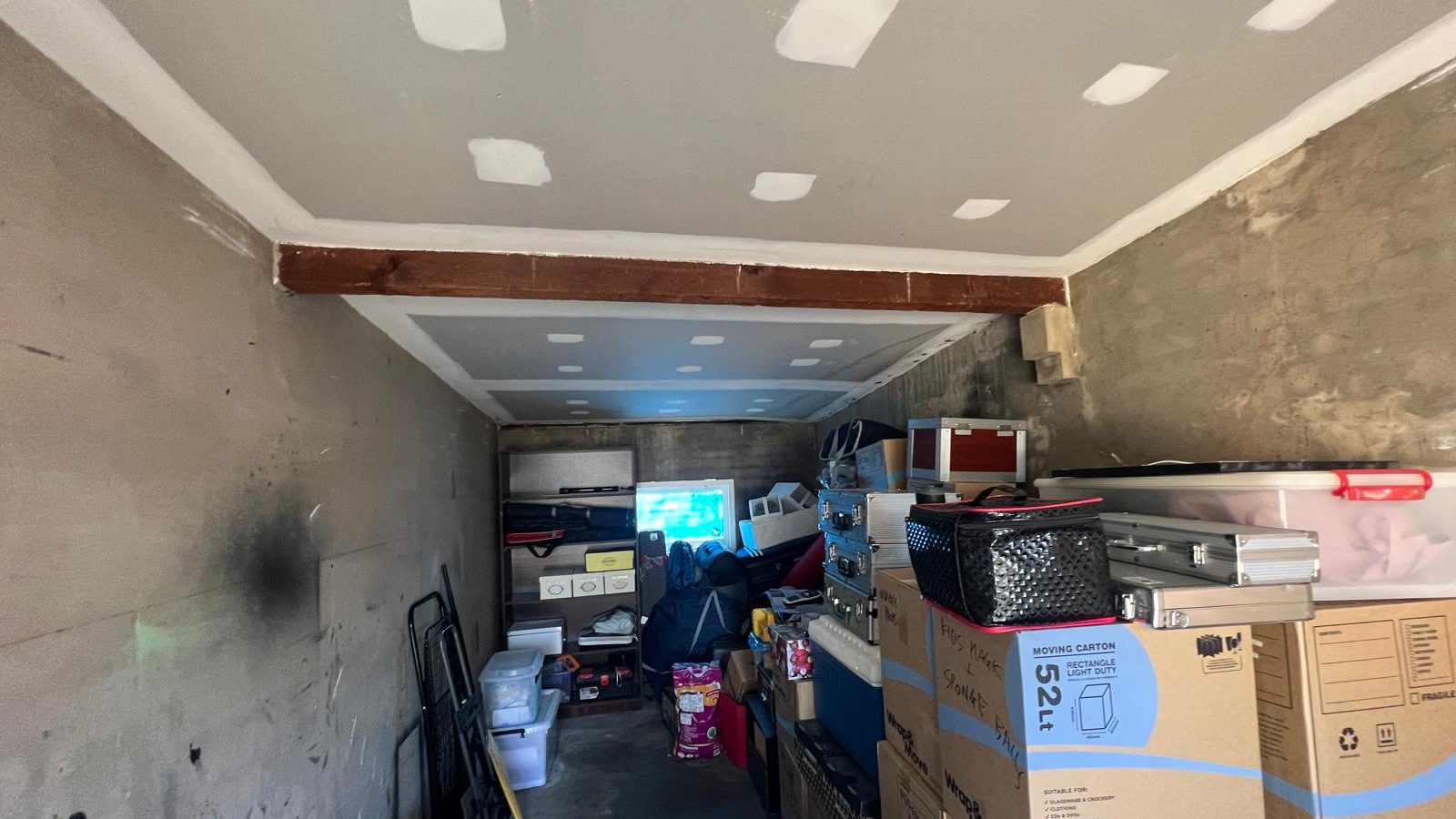 Ceiling set and the fixings spotted, with the original masonry walls left bare below