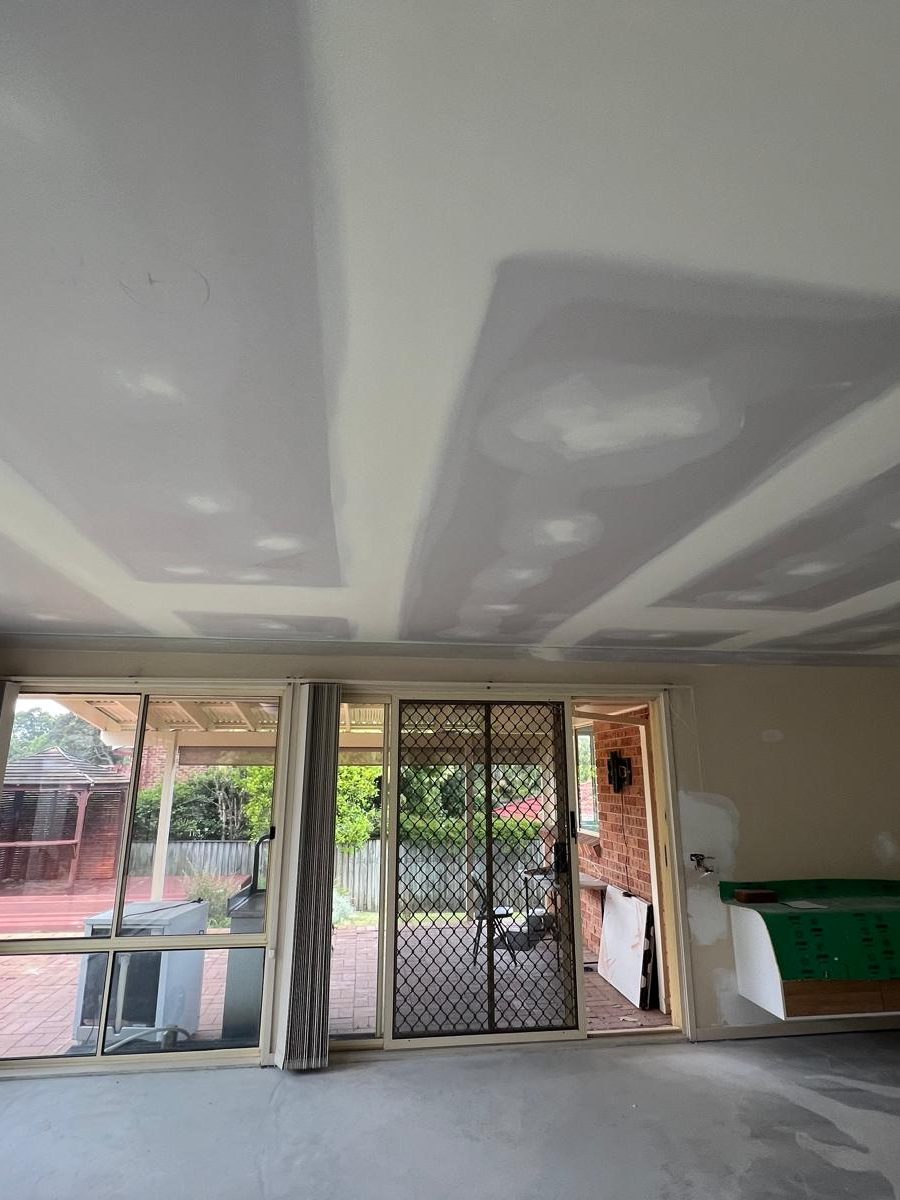 Ceiling set flush and coated above a run of sliding doors