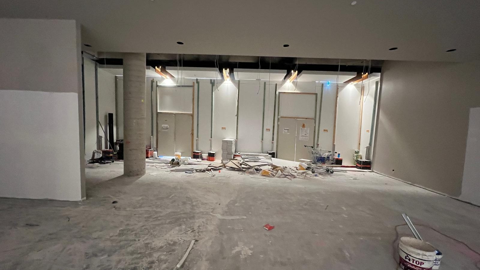 Commercial tenancy stripped back and relined, with new bulkheads and columns set and the floor still bare