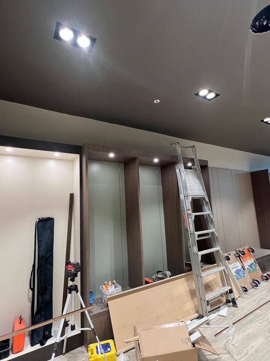 Ceiling set and finished dark with downlights fitted above a run of joinery