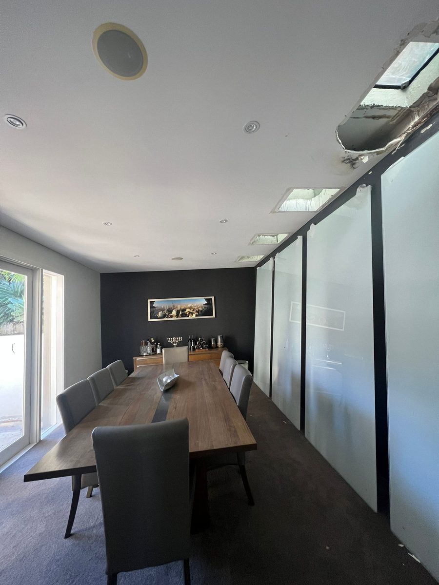 Dining area with the ceiling set and painted beside a glazed partition