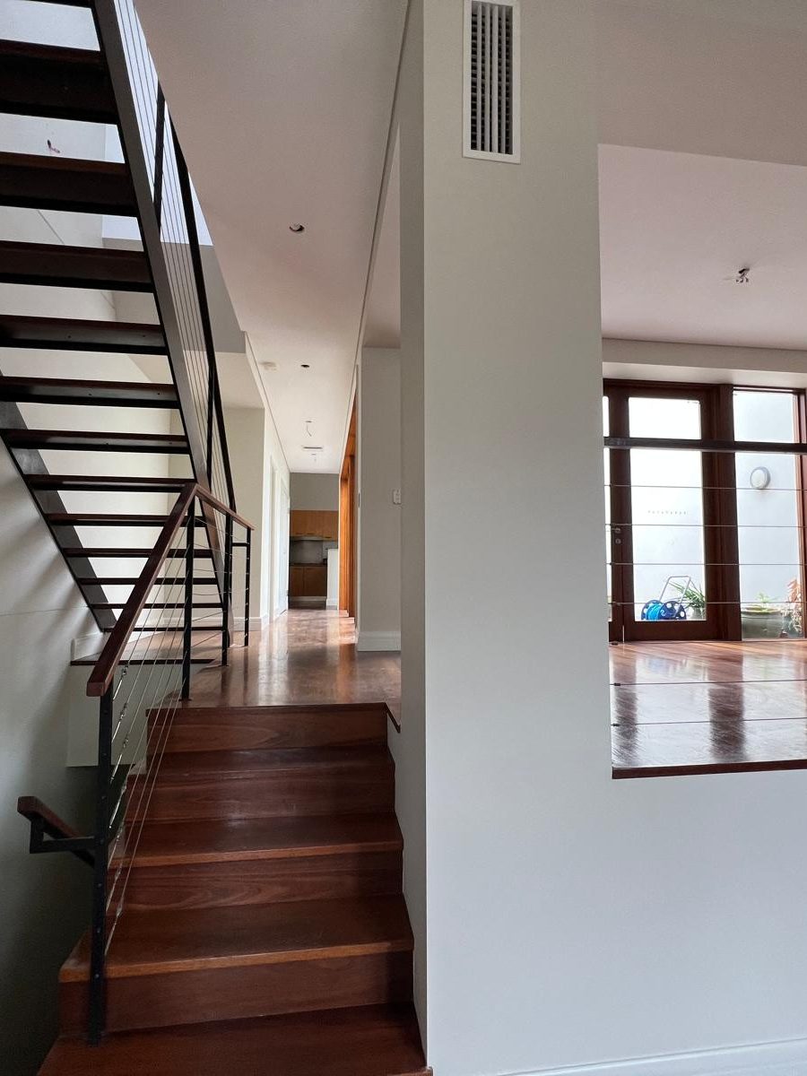 Hall and stair with the walls and ceiling set and painted and a ceiling vent cut in above the landing
