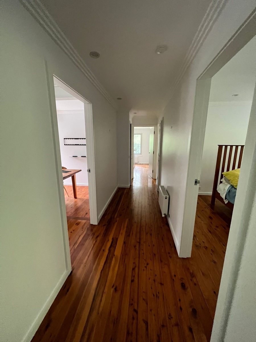 Hallway with the cornice run and the walls and ceiling set, doorways opening off either side