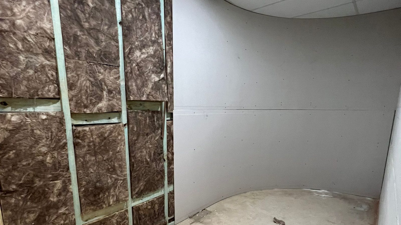 Insulation held between the studs on one side and the finished lining set smooth on the other