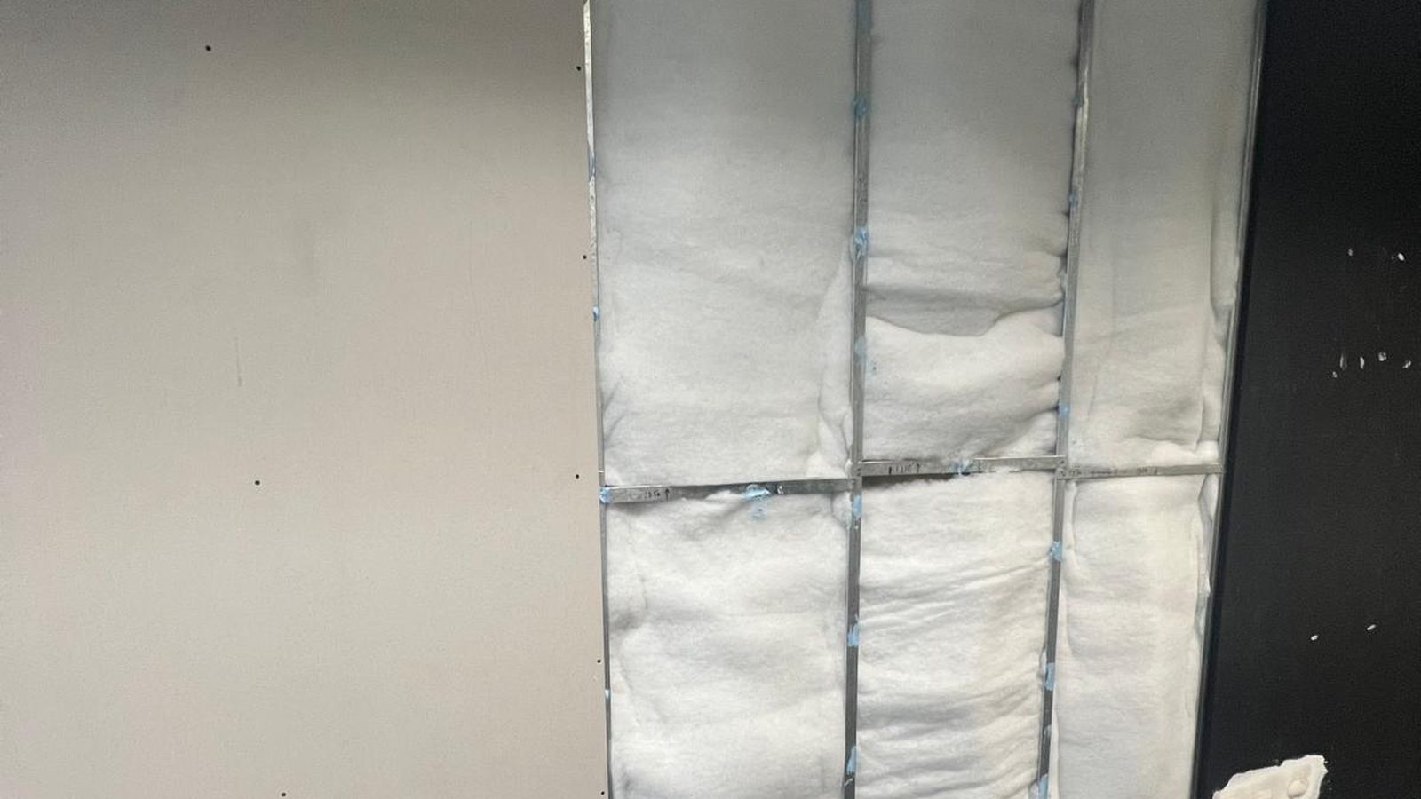 Insulation blanket fixed between the studs with the wall lining sheeted over the rest of the frame