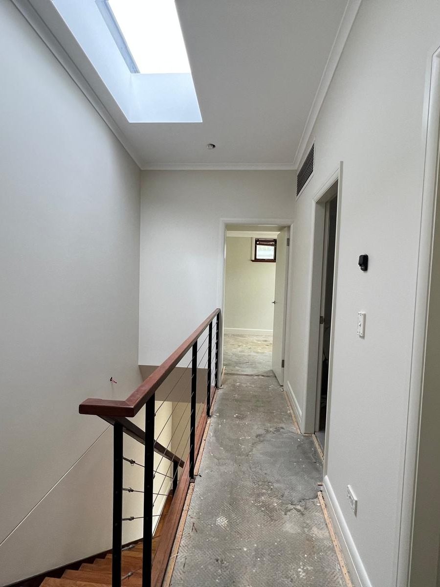 Landing with a skylight set flush into the ceiling and the walls finished either side