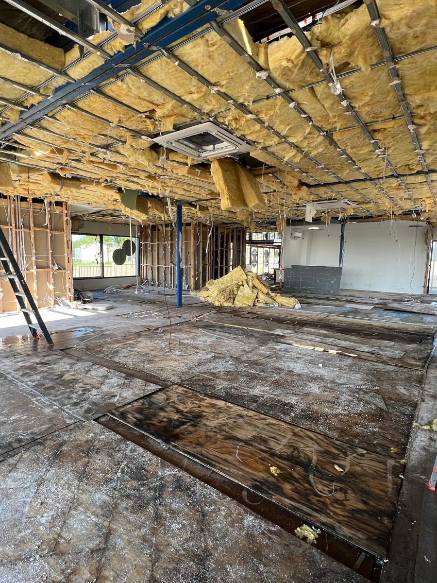 Large tenancy with the ceiling stripped back to the framing and the insulation pulled down