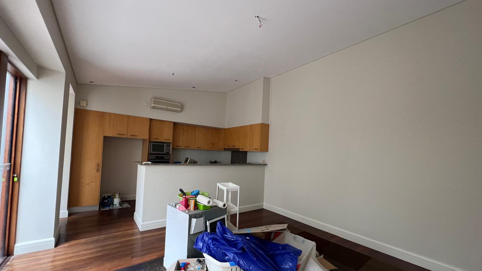 Living and kitchen space with the walls and ceiling set flush and the kitchen joinery in place
