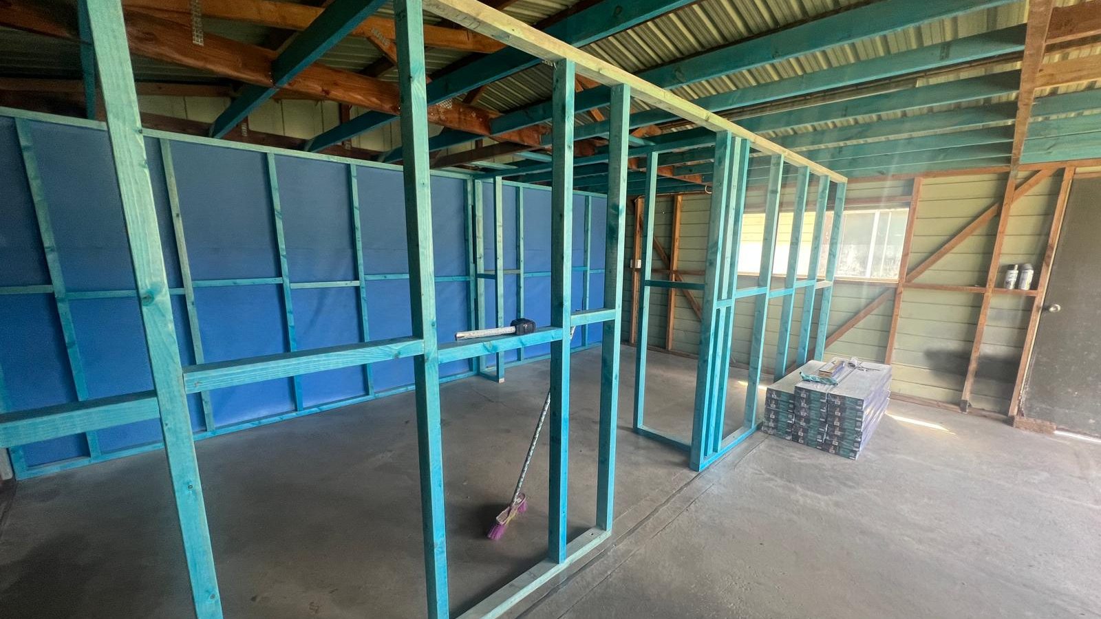 Steel framing set out for partition walls in a large space before the linings go on