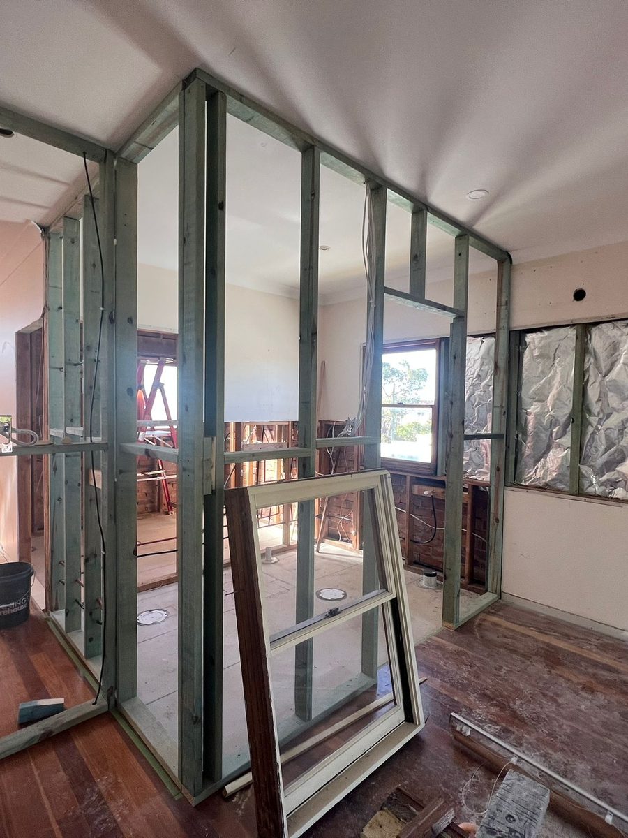 Steel framing set out for a new partition under a ceiling that has already been set