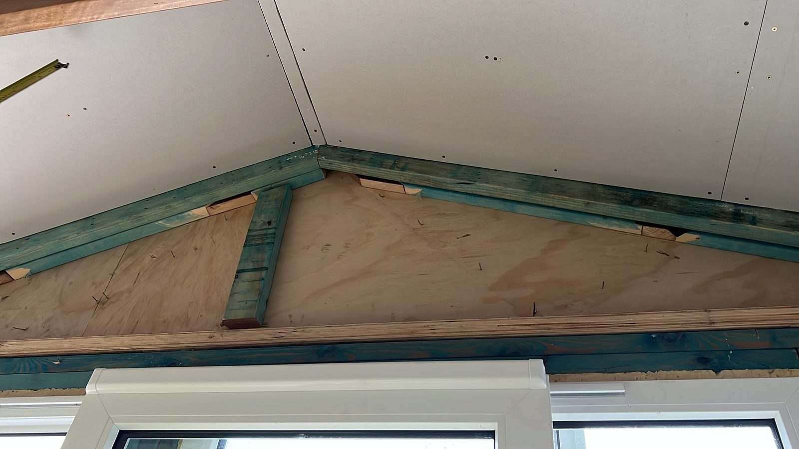 Raked ceiling sheeted in plasterboard on both sides of the timber frame, the joints not yet set