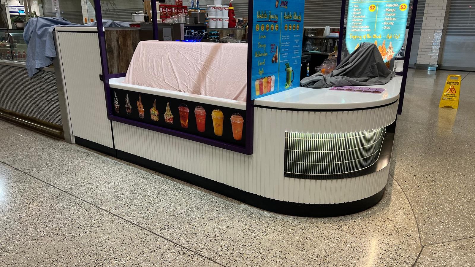Front of a retail counter finished and covered over while the rest of the fit out is completed