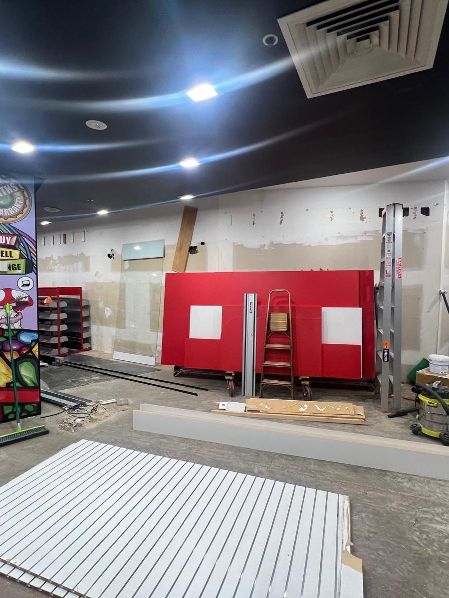 Retail interior with the ceiling set and painted above new fixtures and shelving