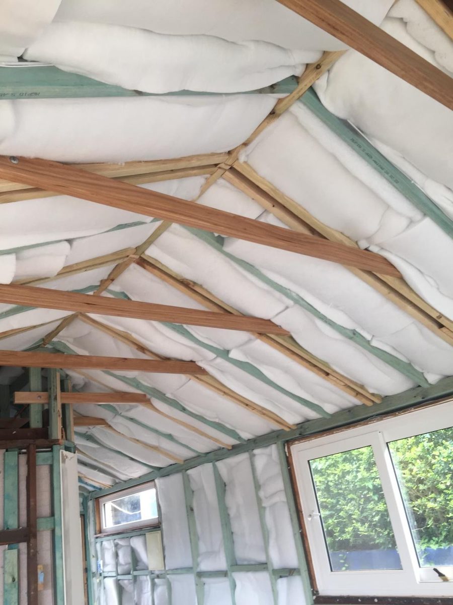 Roof frame with sarking laid over the trusses, seen from inside the room before the ceiling is lined
