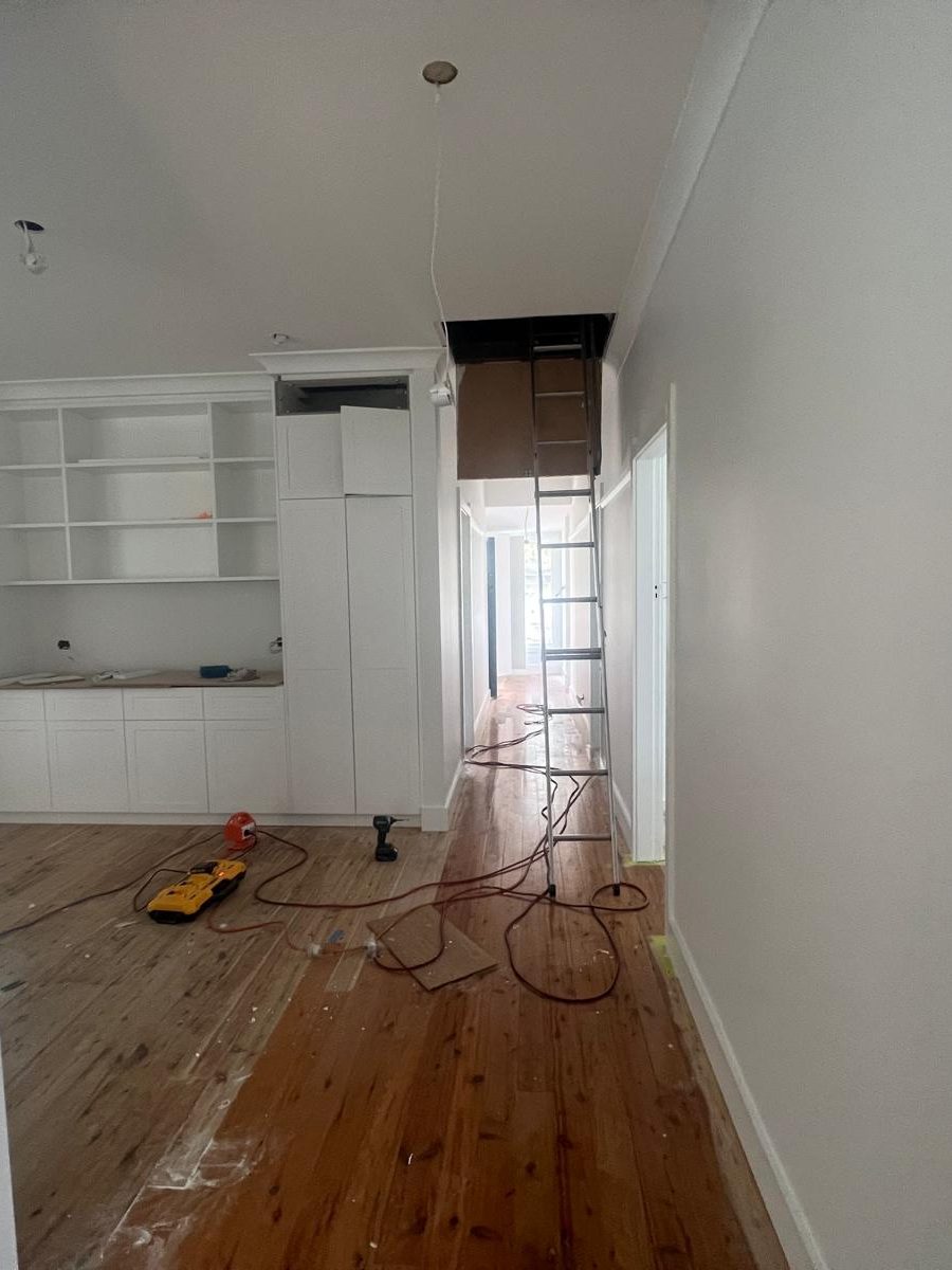 Room with the walls and ceiling set around built in joinery and the floorboards below