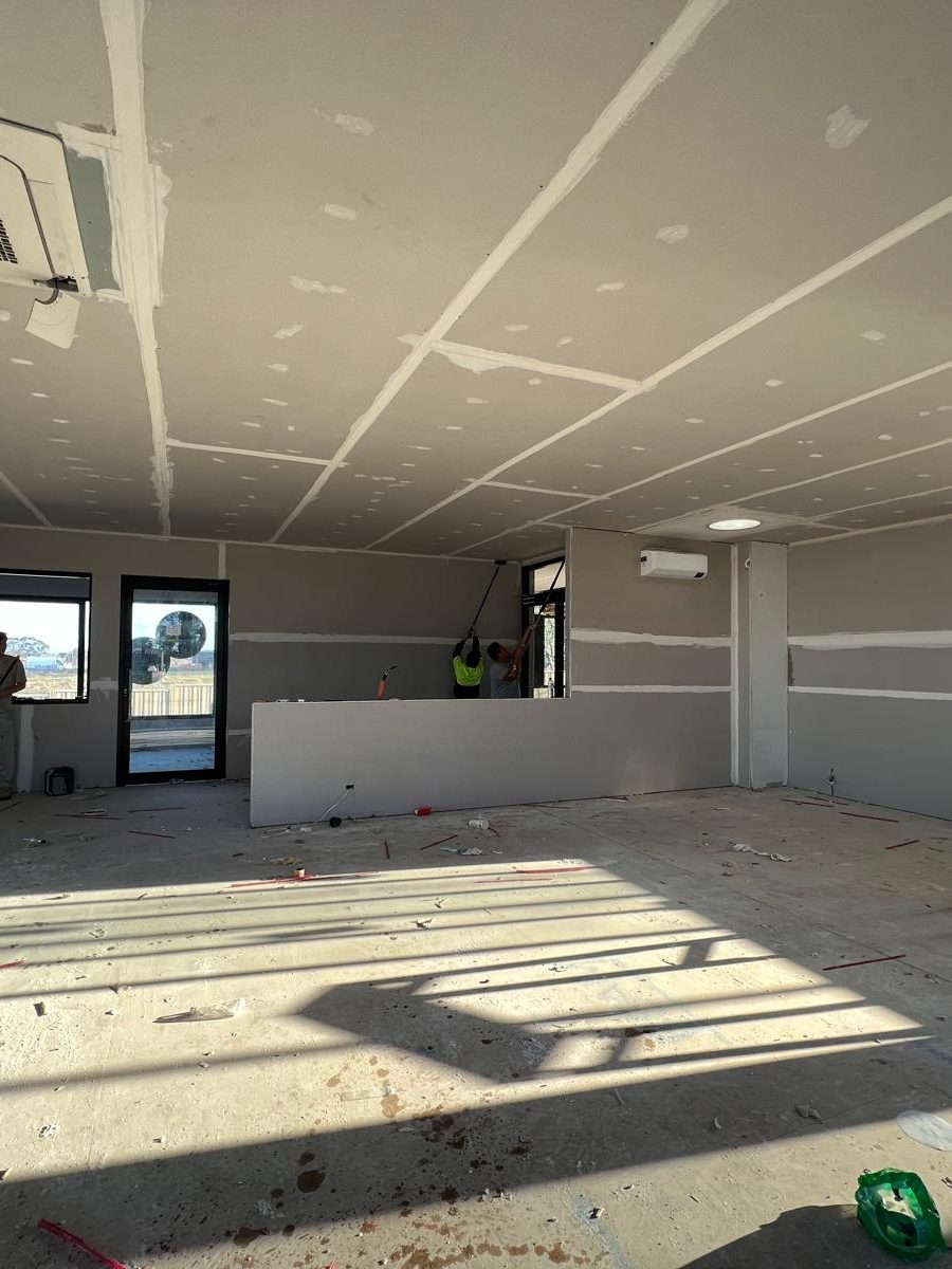 Room sheeted throughout with the ceiling joints coated and the sun across the bare floor