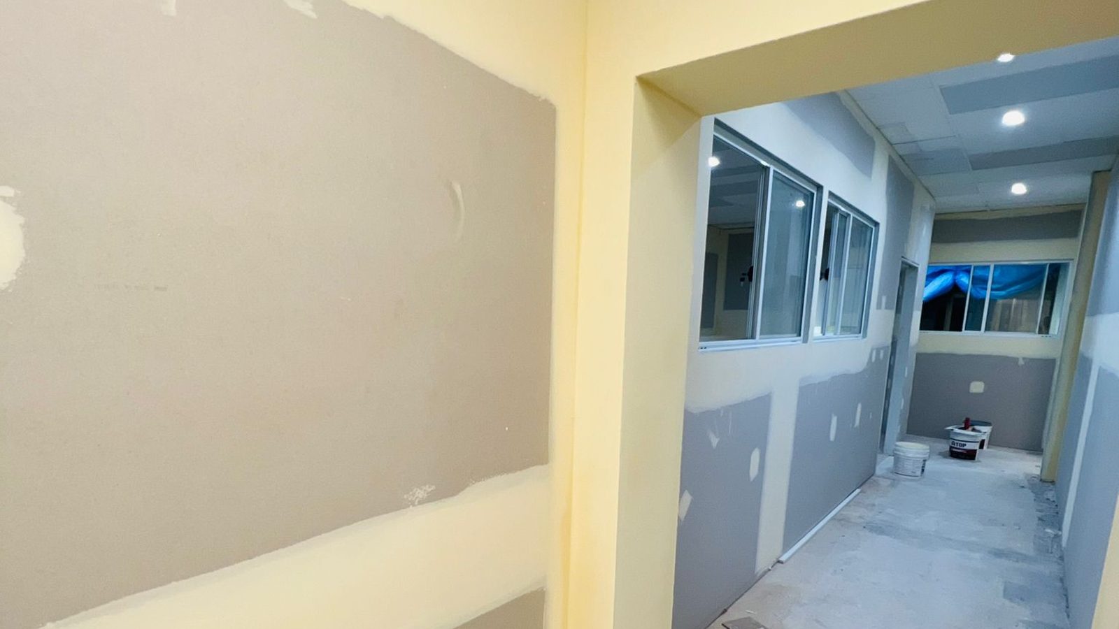 Wall set and coated beside a run of glazed partitions in a fit out