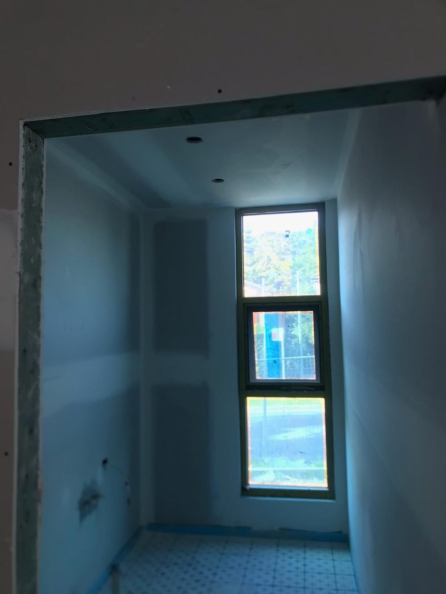 Small room sheeted and coated, with the window reveal lined