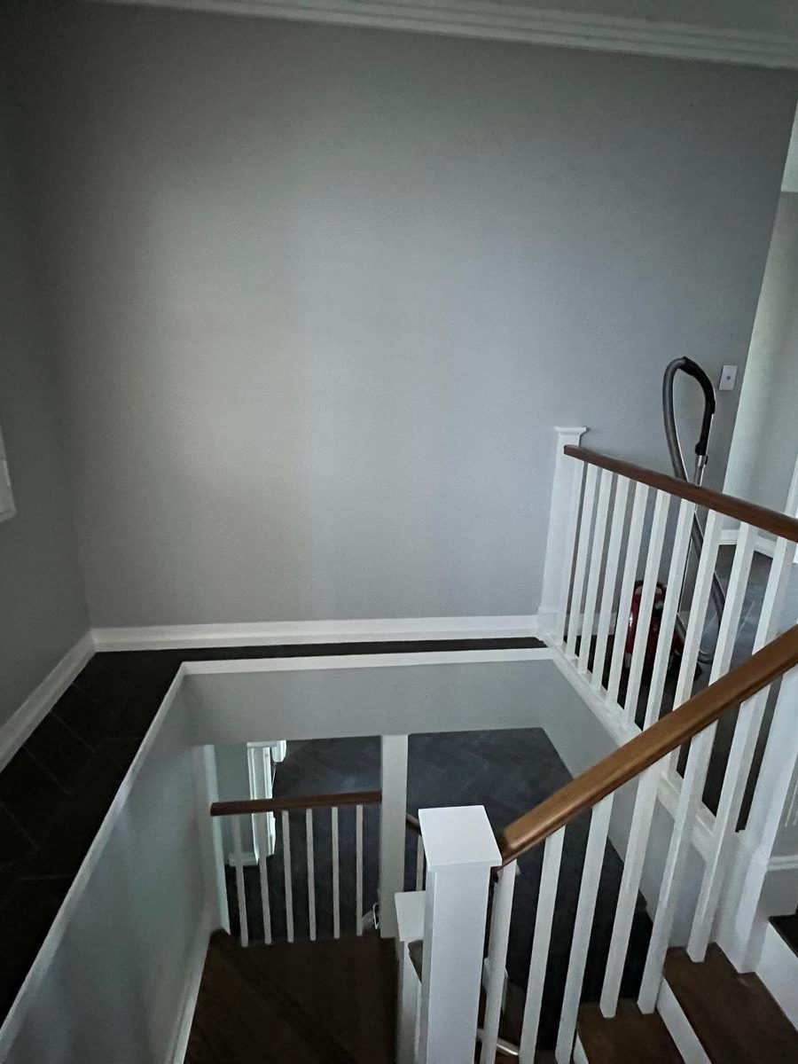 Stairwell with the walls set and finished around a painted timber balustrade