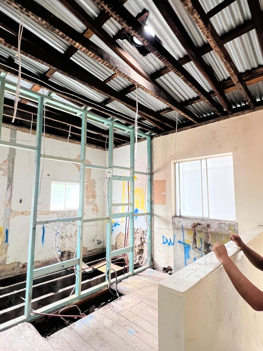 Steel stud framing set out for new walls with the ceiling opened above and the old linings removed